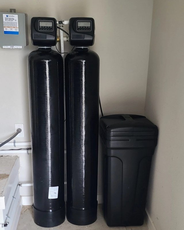 Dual-tank well water system installed in a utility closet